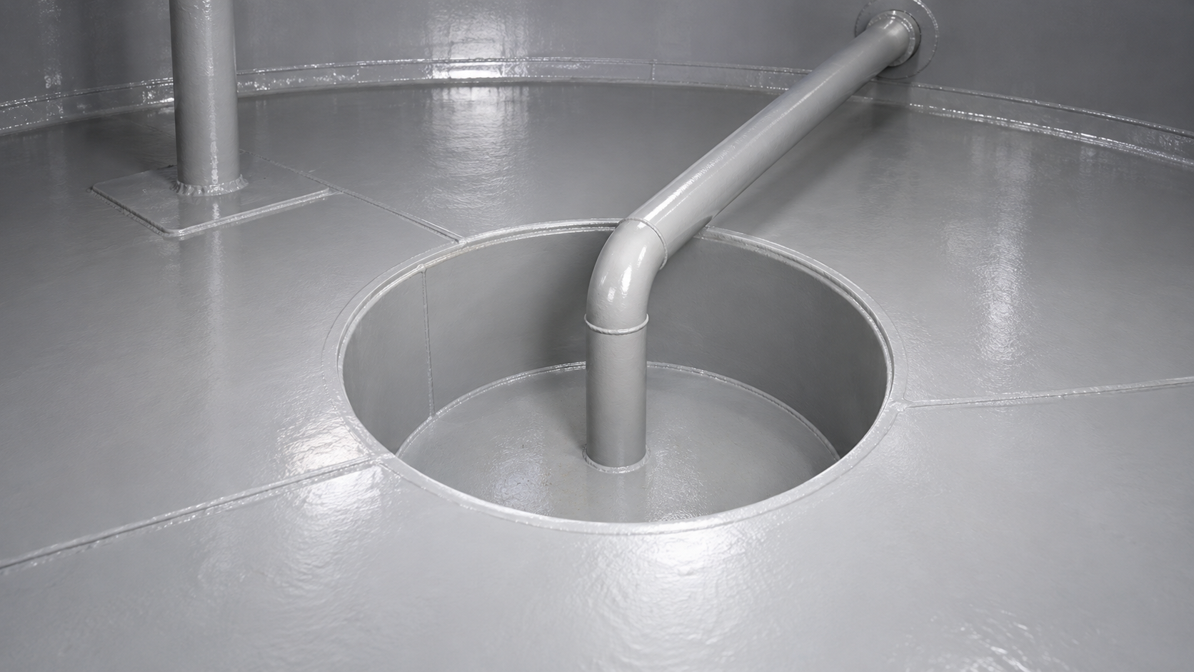 Gray protective lining covering a steel tank floor, recessed sump and connecting pipe.